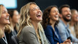© Kevin - Audience laughing and smiling in response to a speaker's engaging presentation