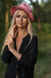© shymar27 - Portrait of a beautiful young blonde girl in a black shirt in the forest.