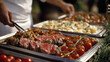 © Daniel - Gourmet Buffet Catering with Sliced Steak  Cherry Tomatoes  and Creamy Pasta