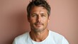 © Руслан Галиуллин - minimalistic portrait of adult caucasian softly smiling man is 40 years old wearing white T-shirt on beige pink color background
