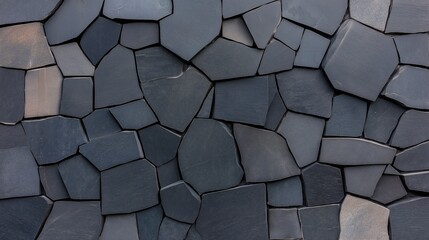 Poster - Wall made of black stones with a rough texture. The wall is made up of many small stones, and it is a part of a larger structure. The wall has a rugged and natural appearance