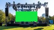 © anis rohayati - Stage modern rigging large outdoor concert with beam lights, sound system, and green blank screen, mockup material background wallpaper AI generated image