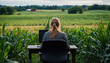 © Александр Марченко - Female farmer working remotely with laptop in corn field