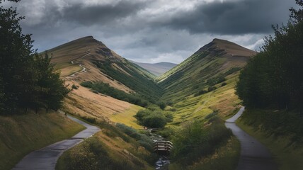 Winding path lined with trees between two green hills with overcast sky