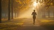 © Irina Kozel - A young woman jogs along a misty path surrounded by trees with autumn foliage, illuminated by soft morning light