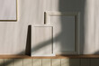 © RooM The Agency - Close-up of blank picture frames in the sunlight on a shelf in a living room