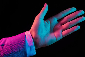 Two hands showing a sale advertisement copy space and black background with burst of colors with colorful glitter style