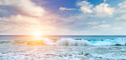 Poster - Sea and bright sun on blue cloudy sky.