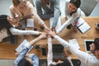 © Prostock-studio - Group of people putting their hands together for united, cooperation and teamwork concept, top view