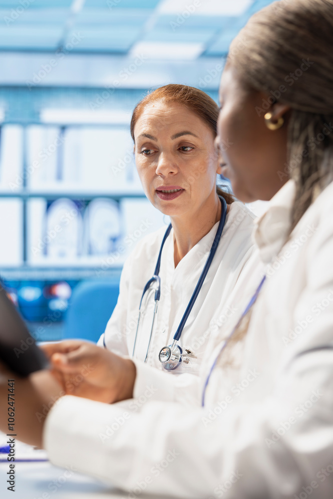 Diverse doctors team examining x ray scan results for effective ...