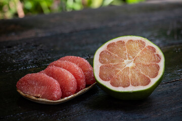 Wall Mural -  Pomelo or Citrus maxima fruit on an old wooden background.