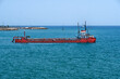 © Ernesto Sevilla - Suction dredger near coastal town with marina in background
