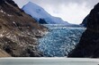 © Tenzin & Li - Majestic Chorten Nyima Glacier in Tibet, showcasing intricate ice formations against rugged mountain slopes, a breathtaking view of natural beauty.