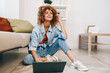 © SHOTPRIME STUDIO - Smiling Woman Using Laptop in Cozy Living Room, Embracing Modern Freelance Lifestyle