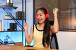 © Thitisak - Young Asian woman listening to music, happy