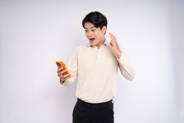 Portrait of young asian businessman wearing sweater and using phone on white background