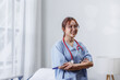 © David - Portrait of happy female nurse or doctor wear scrub at work. Beautiful young woman clinical nurse or physician in medical uniform standing in office,