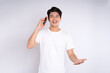 © STOCK88PHOTOGRAPHER - Portrait of young asian man using phone on white background