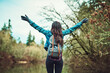 © Camerene P/peopleimages.com - Woman, backpack and hiking with arms raised by lake for goal, success or memory on vacation in nature. Person, cheers and bag for achievement by water, river or celebration on adventure in Costa Rica