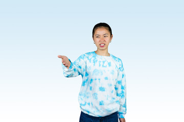 Wall Mural - Yougn Asian girl with blue dress points and gives various expression and gestures isolated happy sad