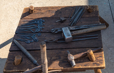 An old blacksmithing tool is lying on the table