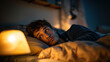 © Xingguo - Anxious people lying in bed with eyes wide open, unable to sleep due to insomnia, showing worry and fatigue, the room is dimly lit and the soft light of the bedside lamp creates a calm but uneasy atmo