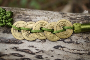 Wall Mural - Chinese Feng Shui coins on a wooden background.