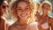 © sandi - Happy young woman with friends on the beach, holding a pink smoothie.