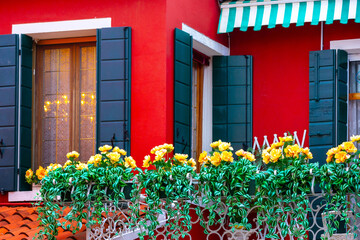 Burano, Italy red house windows street view