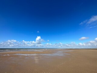 vast sand beach under the deep blue sky near ainsdale-on-sea, england, united kingdom, august 2023