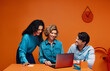 © Jacob Lund - A strong creative team of adults brainstorming with a laptop in an office setting