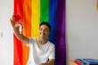 © ADDICTIVE STOCK - Trans man celebrating new home against a pride flag background