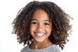© Attasit - Cute African American Asian girl smiling brightly showing healthy white teeth and looking directly at the camera with her hair in natural curls Isolated on white background