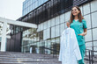 © Dragana Gordic - Confident Medical Professional Holding White Coat Outdoors