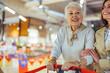 © Dragana Gordic - Joyful Senior Woman Shopping With Her Adult Daughter