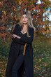 © T.Den_Team - Autumn - winter collection. Blonde woman in wool coat on a city park background. Modern classical ladies wardrobe