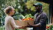 © Alexey - Black male farmer giving box full of fresh vegetables to caucasian woman at farmers market