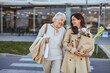 © Dragana Gordic - Happy Senior Woman and Daughter Carrying Groceries Outdoors