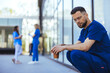 © Dragana Gordic - Contemplative Medical Professional Outdoors Holding Coffee Cup