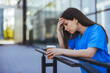 © Dragana Gordic - Stressed Nurse in Scrubs Holding Coffee Cup Outdoors