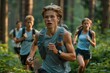 © neatlynatly - A group of young runners participates in a cross-country race, navigating through a lush, green forest. They appear focused and determined as they move forward.