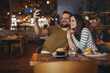 © Dragana Gordic - Happy Couple Taking Selfie in Cozy Restaurant Setting