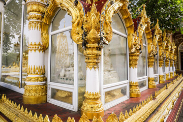 Wall Mural - Wat Phra That Nong Bua, Ubon Ratchathani, inside there is the Phra That Sri Maha Bodhi Chedi, a replica of the Chedi in Bodh Gaya, India, stucco sculptures, candles, and two large Naga statues.