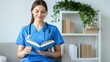 © wannathon - Nurse Reading Book in Cozy Home Office Setting