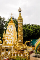 Wall Mural - Wat Phra That Nong Bua, Ubon Ratchathani, inside there is the Phra That Sri Maha Bodhi Chedi, a replica of the Chedi in Bodh Gaya, India, stucco sculptures, candles, and two large Naga statues.