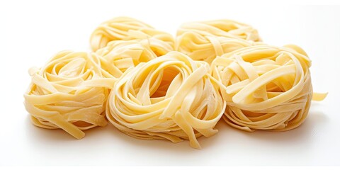 Isolated on a white background, you will find a stack of fettuccine nests, showcasing their unique shape and texture in a visually appealing manner.