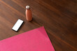 © Wavebreak Media - Yoga mat, smartphone, and water bottle on wooden floor for home workout, copy space