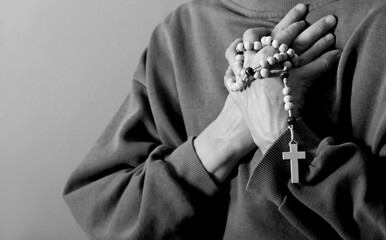 praying to god with hands together on grey background with people stock photo stock image	