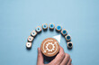 © Dilok - Hand turning wooden knob of mechanical gear with measuring level gauge for product and service quality continuous improvement or Kaizen concept.