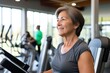 © Ceballos - Woman is sitting on a stationary bike in a gym